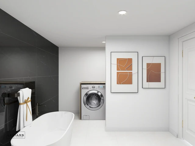 Recessed washing machine beside bathtub and white sliding door