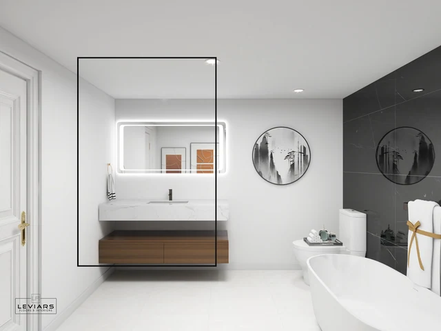 Glass bathroom partition beside wood vanity and illuminated mirror