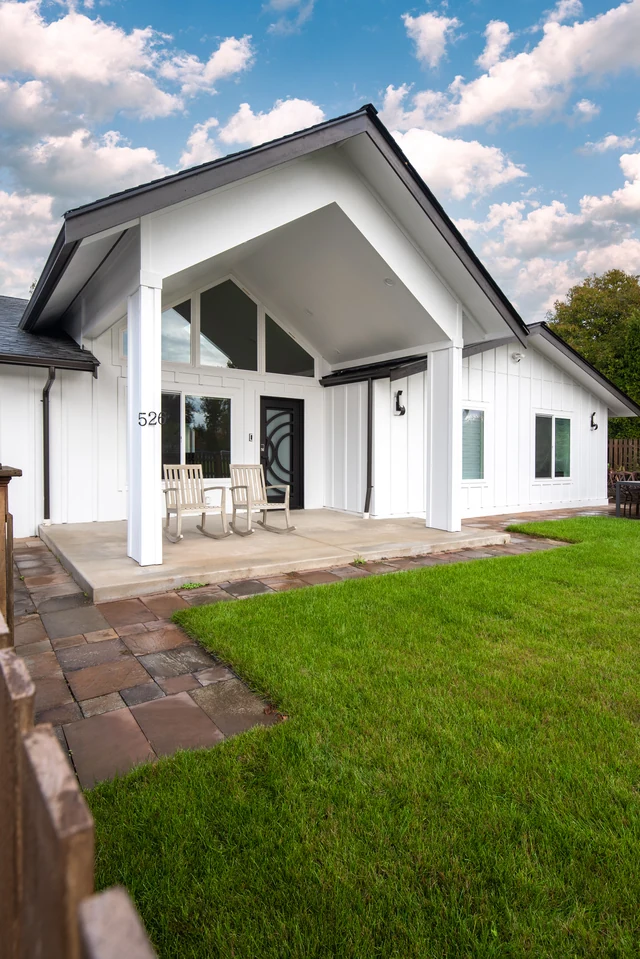Exterior view of the remodeled home and lawn