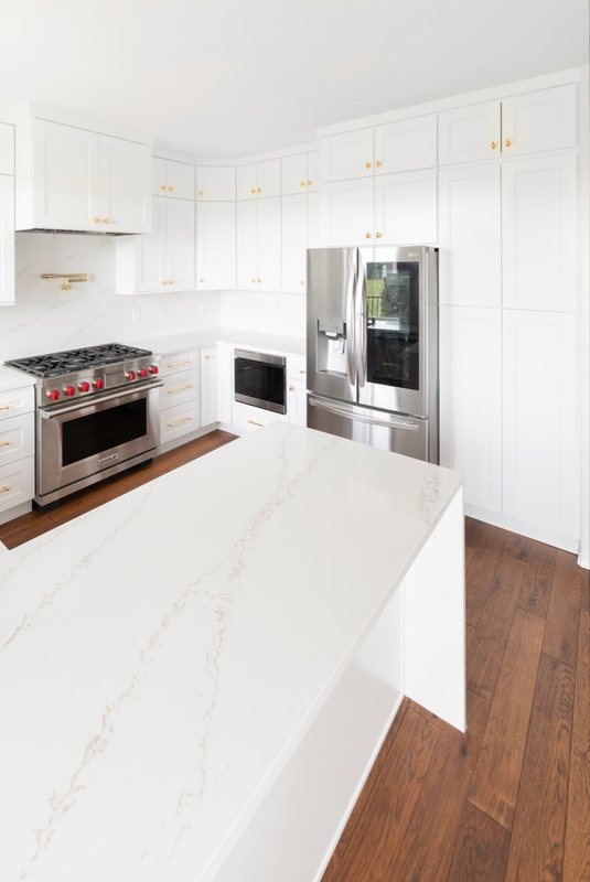 Custom white chef kitchen with professional appliances and tailored cabinetry, view 1 of 17