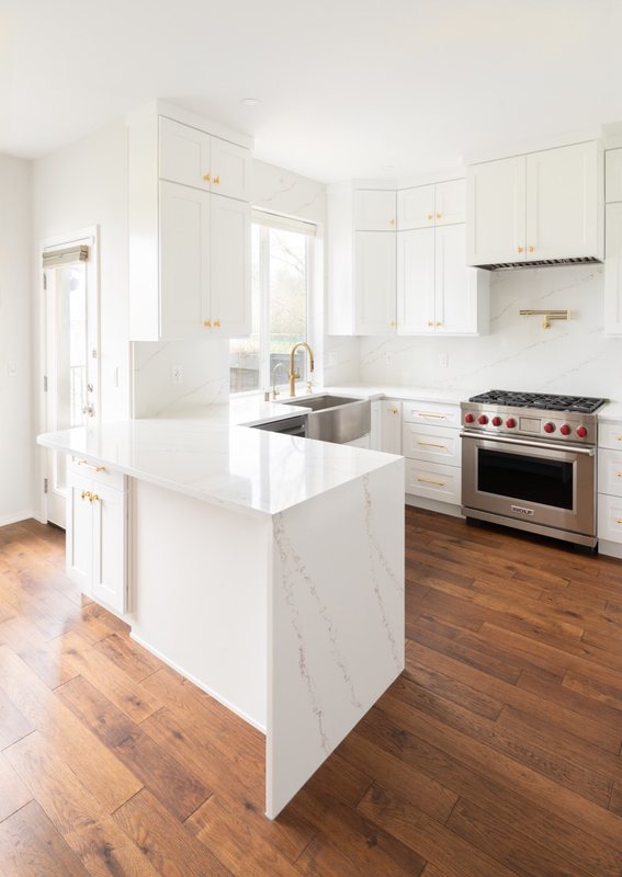Custom white chef kitchen with professional appliances and tailored cabinetry, view 4 of 17