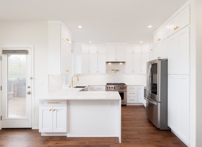 Custom white chef kitchen with professional appliances and tailored cabinetry, view 5 of 17