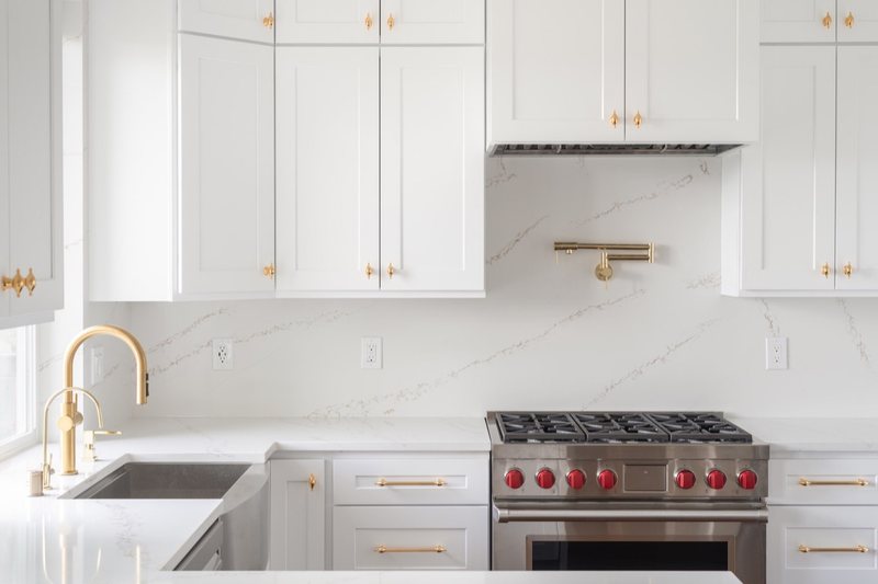 Custom white chef kitchen with professional appliances and tailored cabinetry, view 7 of 17