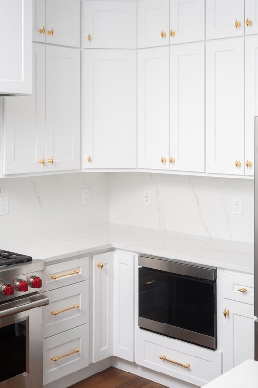 Custom white chef kitchen with professional appliances and tailored cabinetry, view 8 of 17