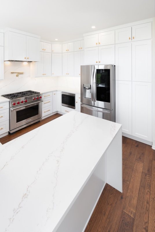Custom white chef kitchen with professional appliances and tailored cabinetry, view 11 of 17