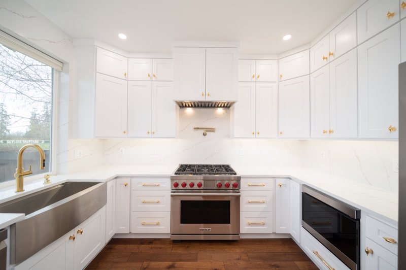 Custom white chef kitchen with professional appliances and tailored cabinetry, view 12 of 17