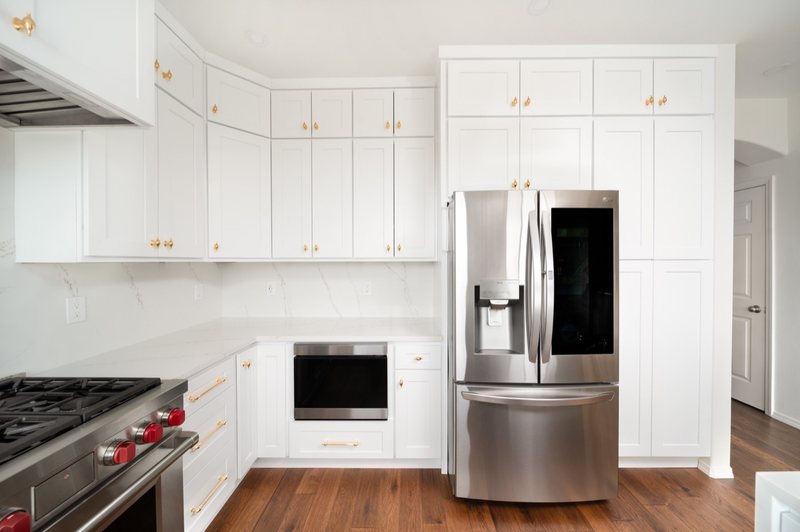 Custom white chef kitchen with professional appliances and tailored cabinetry, view 13 of 17