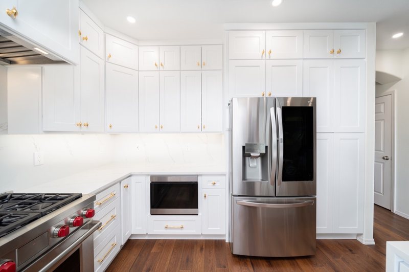Custom white chef kitchen with professional appliances and tailored cabinetry, view 14 of 17
