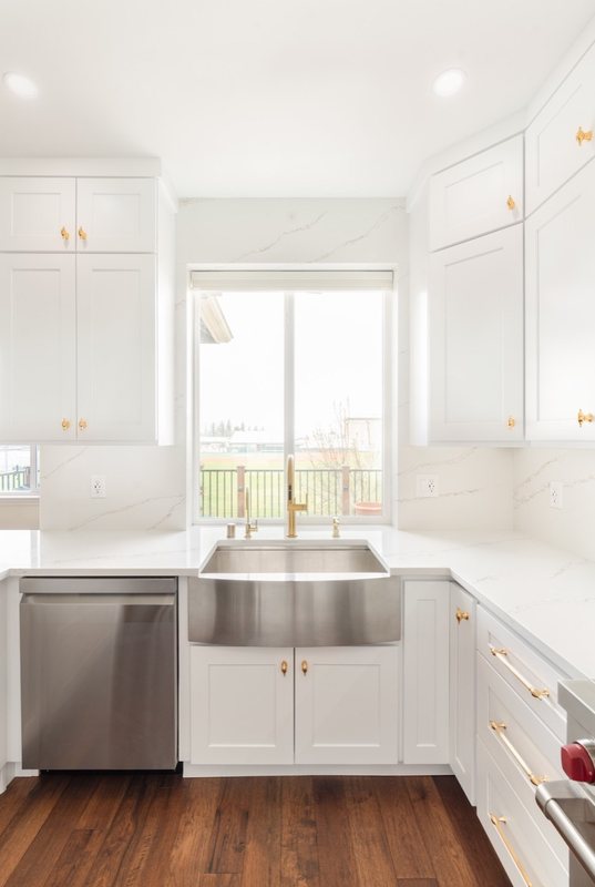 Custom white chef kitchen with professional appliances and tailored cabinetry, view 16 of 17