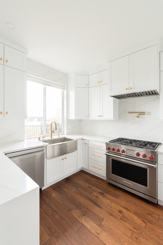 Custom white chef kitchen with professional appliances and tailored cabinetry, view 17 of 17