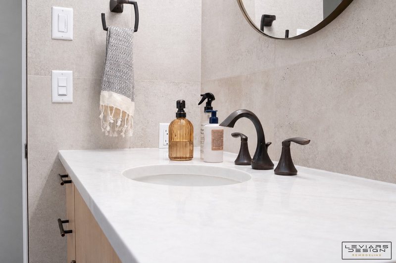 Warm modern bathroom with wood-look tile and black fixtures, view 2 of 8