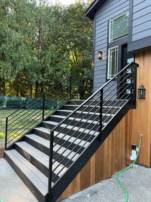 Custom black metal stair railing and handrail installation detail, view 4 of 18