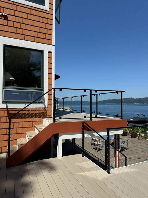 Custom black metal stair railing and handrail installation detail, view 8 of 18