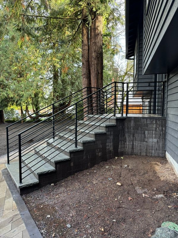 Custom black metal stair railing and handrail installation detail, view 10 of 18