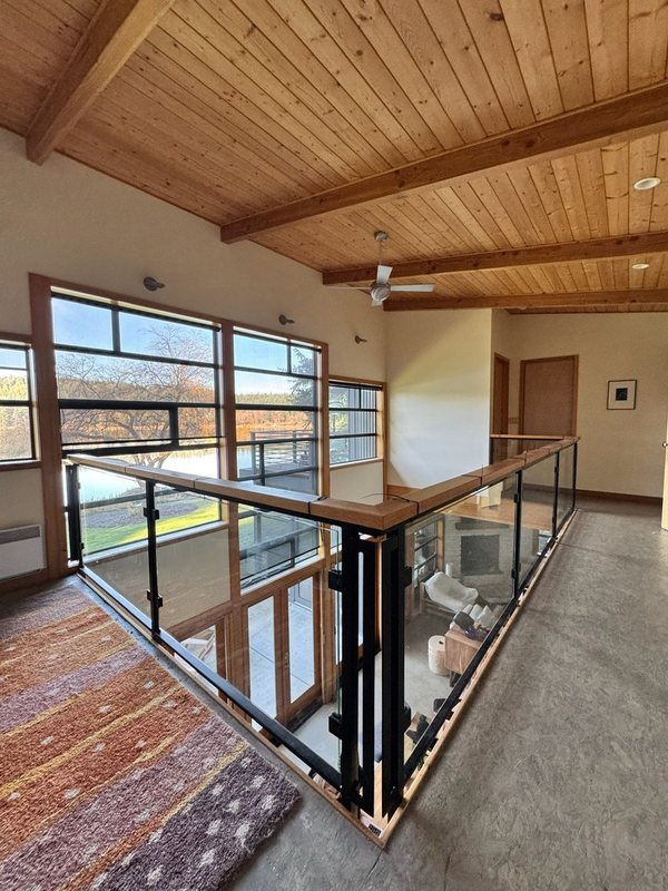 Custom black metal stair railing and handrail installation detail, view 12 of 18