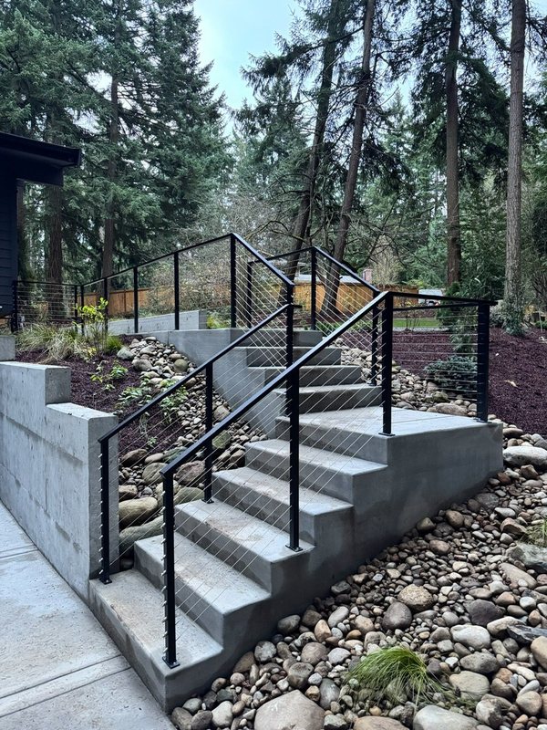 Custom black metal stair railing and handrail installation detail, view 13 of 18