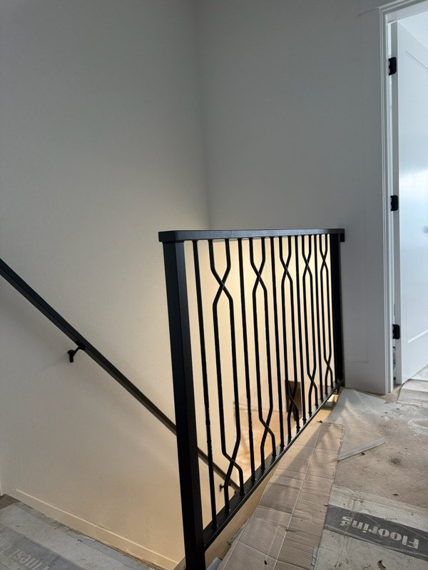 Custom black metal stair railing and handrail installation detail, view 16 of 18