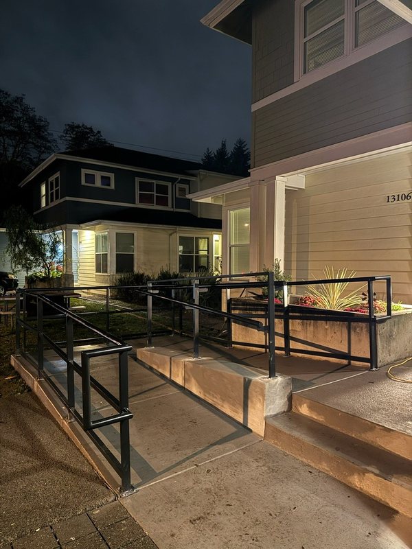 Custom black metal stair railing and handrail installation detail, view 17 of 18