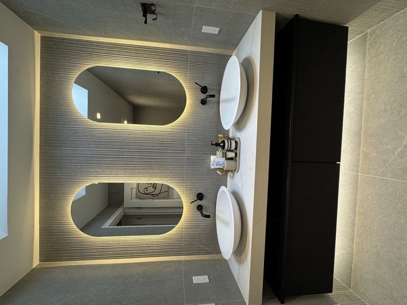 Modern remodeled bathroom with coordinated tile, lighting and storage, view 1 of 9