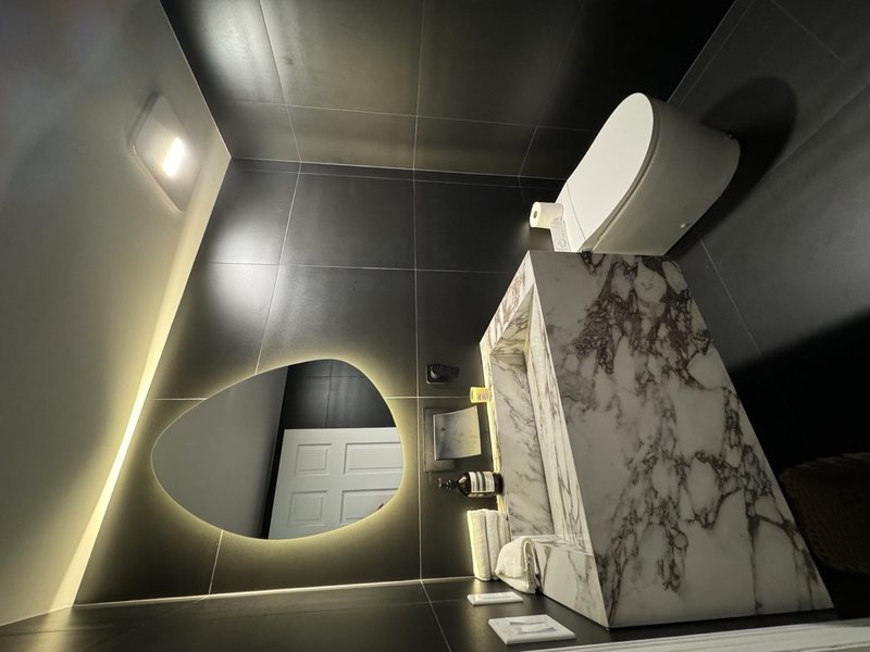 Modern remodeled bathroom with coordinated tile, lighting and storage, view 9 of 9
