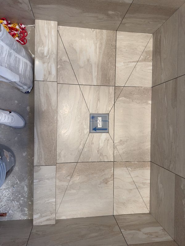 Stone-look tiled shower during construction