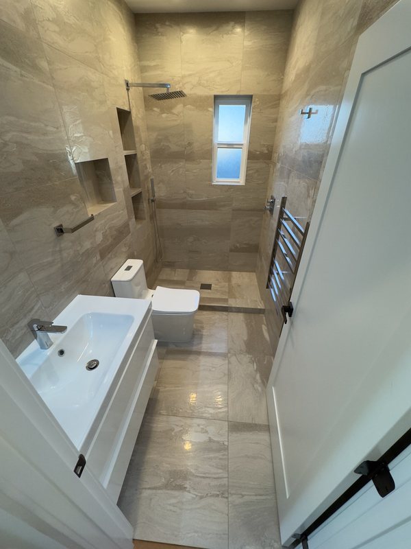Bathroom vanity, tiled walls and glass shower
