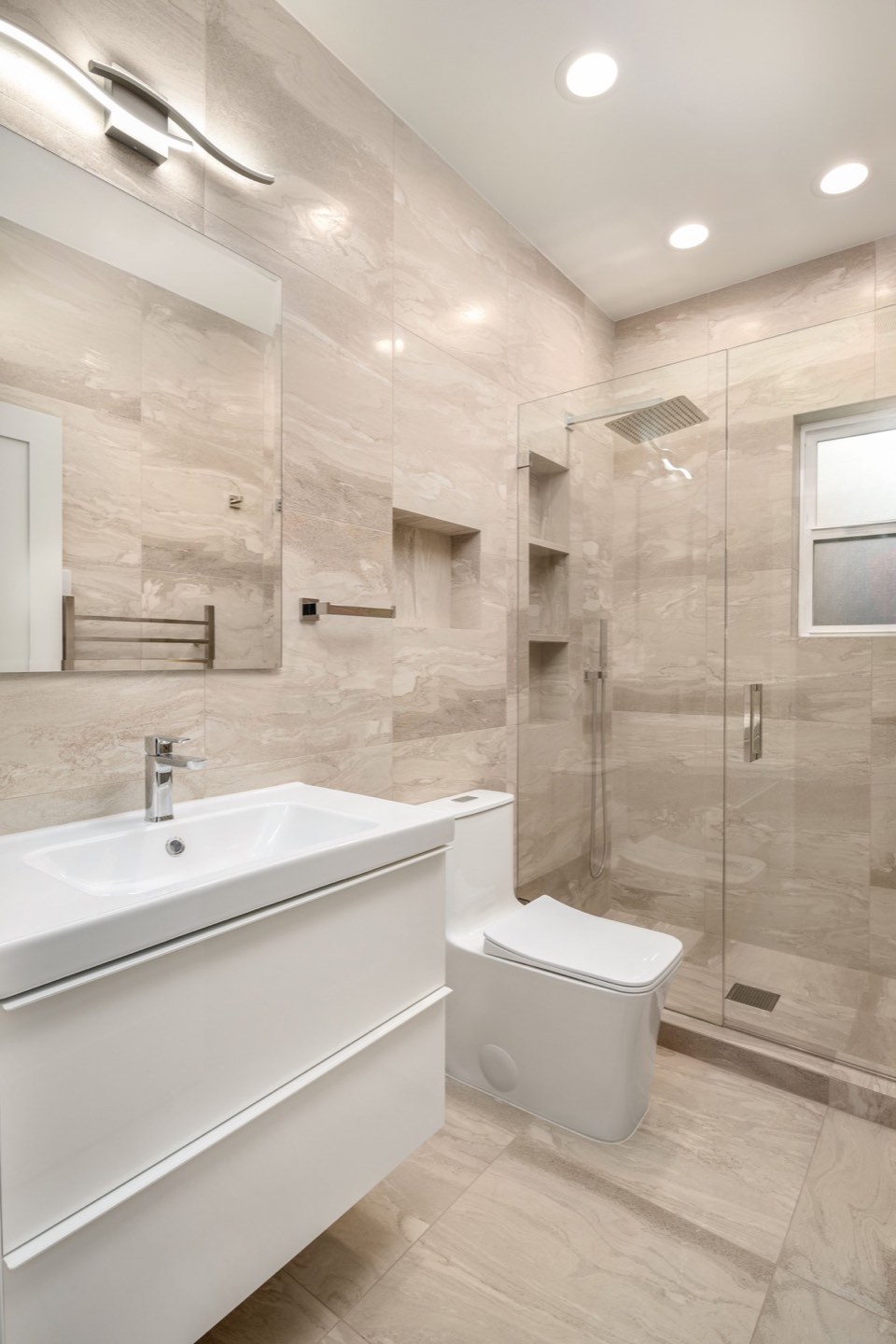 White vanity and stone-look tiled shower in the Branislav bathroom