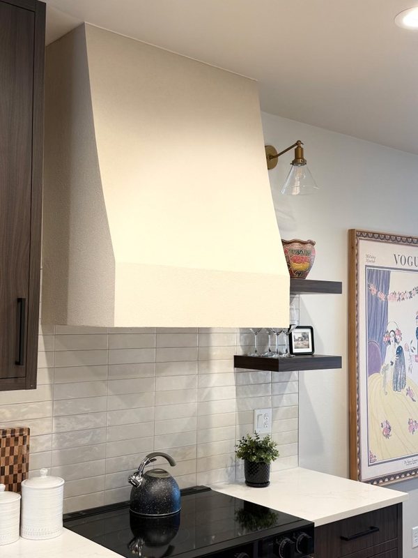 Custom sculpted plaster range hood above a remodeled kitchen range, view 3 of 6