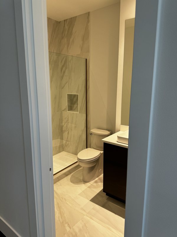 Large-format porcelain bathroom with a glass walk-in shower