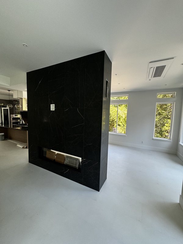 Reverse view of the porcelain fireplace feature wall within the completed whole-home remodel