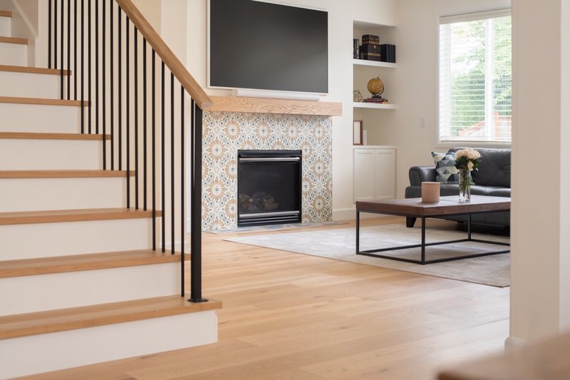Connected whole-home interior with dining room, stairs, fireplace and flooring, view 3 of 12