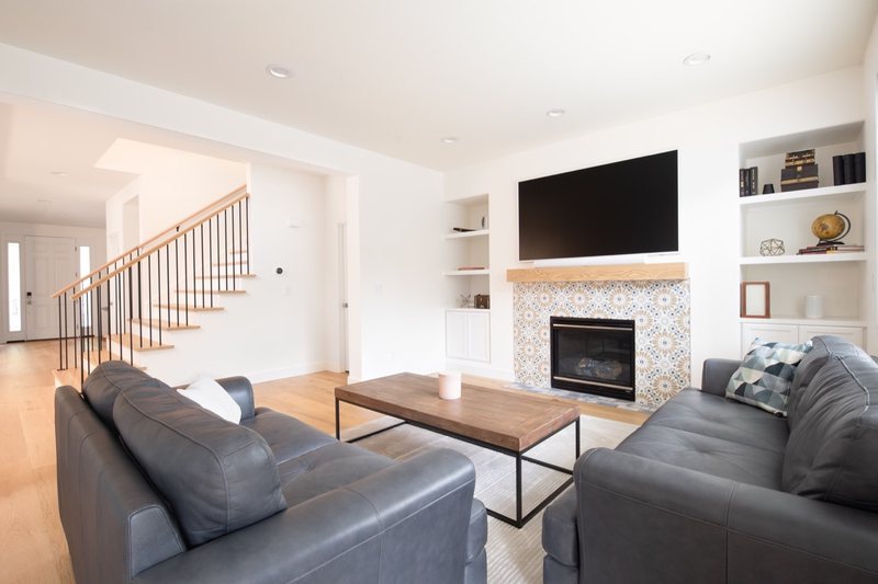 Connected whole-home interior with dining room, stairs, fireplace and flooring, view 7 of 12