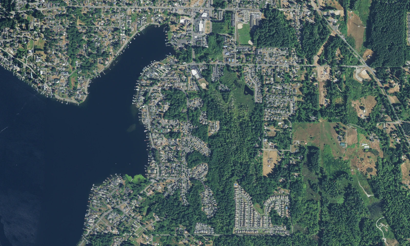 Aerial view of Lake Stevens, Washington, with lakeside neighborhoods, tree cover and the water's edge. LeviArs Design & Remodeling service area.