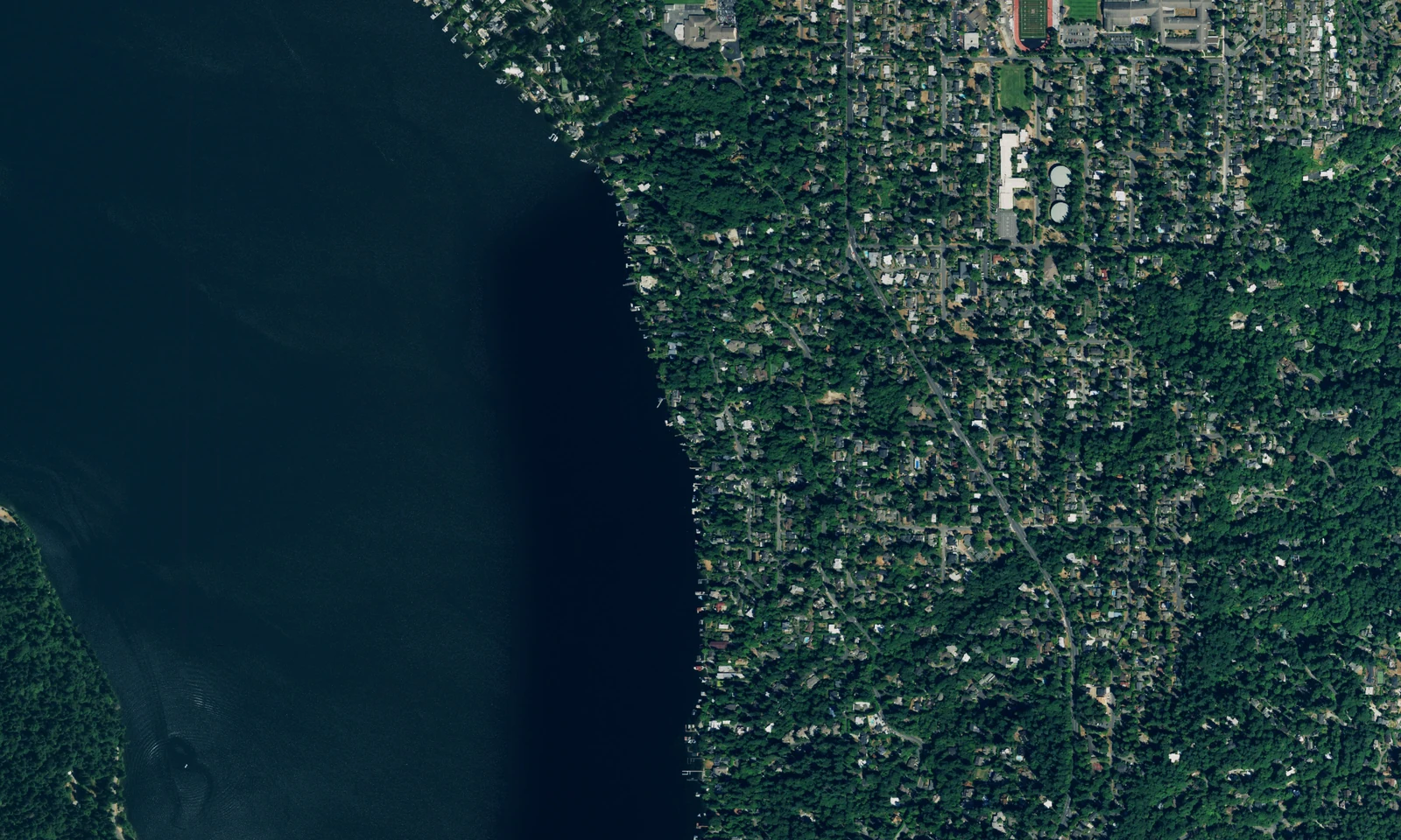 An aerial view of Mercer Island, Washington, showing the wooded residential shoreline beside Lake Washington. LeviArs Design & Remodeling service area.