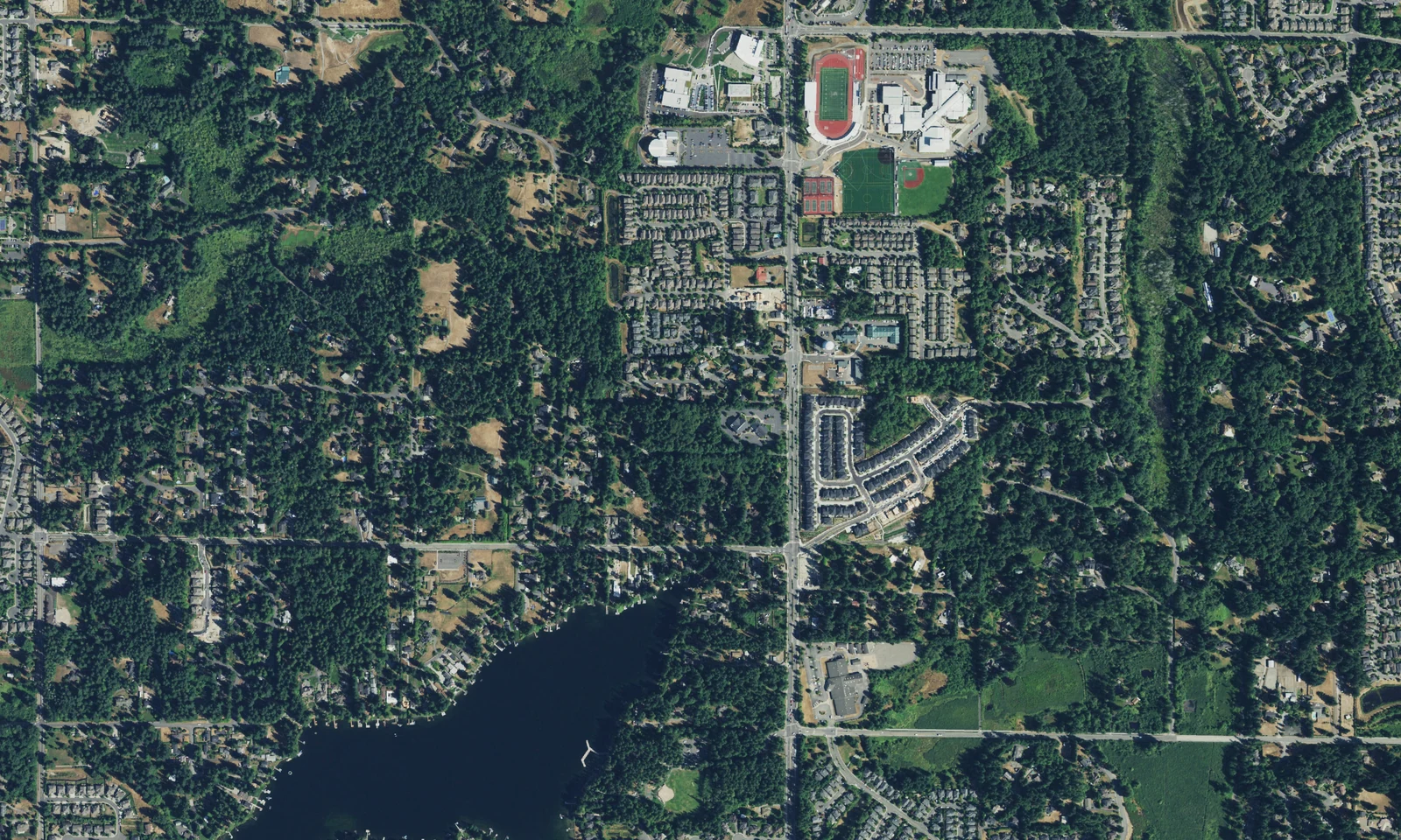 Sammamish, Washington, from above, with wooded residential neighborhoods, lakes and school playing fields. LeviArs Design & Remodeling service area.