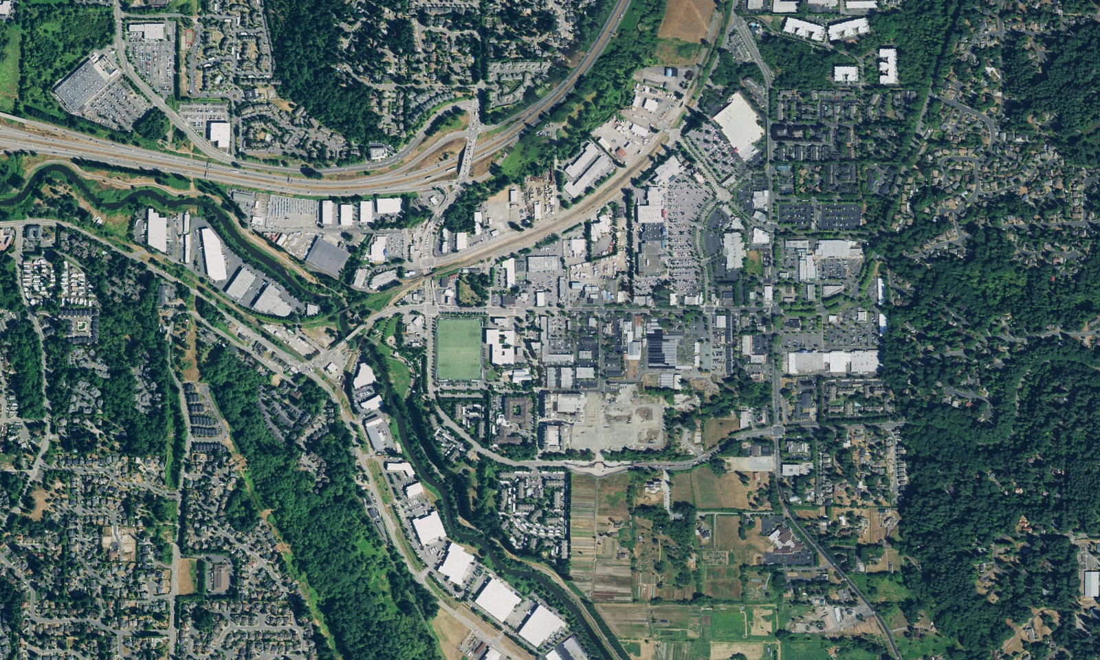 Woodinville, Washington, from above, with its town center, Sammamish River corridor and wooded neighborhoods. LeviArs Design & Remodeling service area.