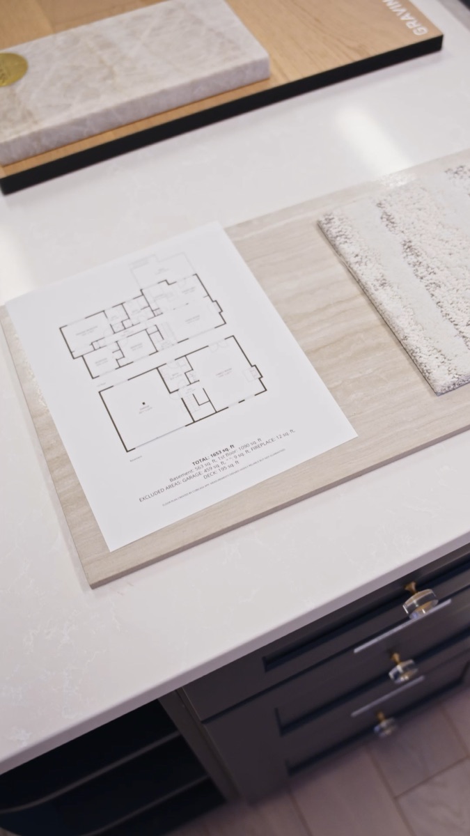 Printed floor layout reference beside material samples at the LeviArs Design Center