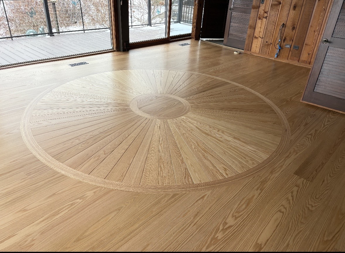 Circular parquet design in hardwood flooring. Flooring options with LeviArs Design & Remodeling.