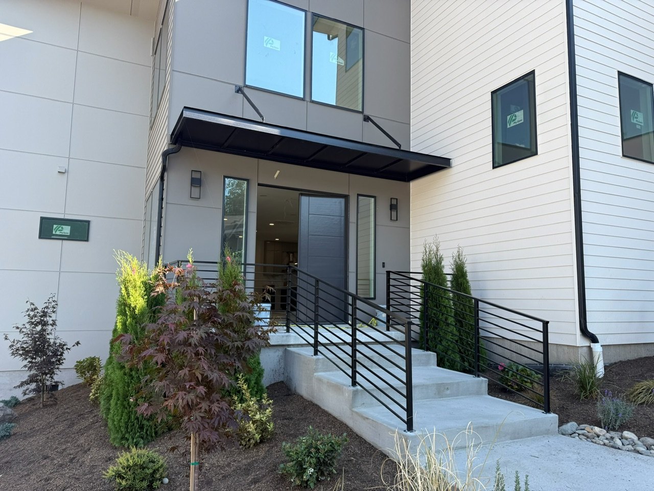 House exterior with white siding, contrasting gray panels and dark trim