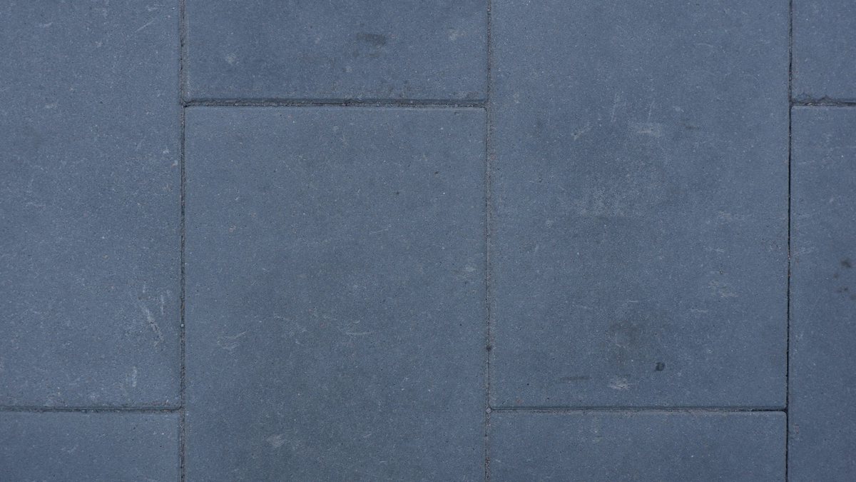 Dark gray rectangular concrete patio paving blocks with staggered joints