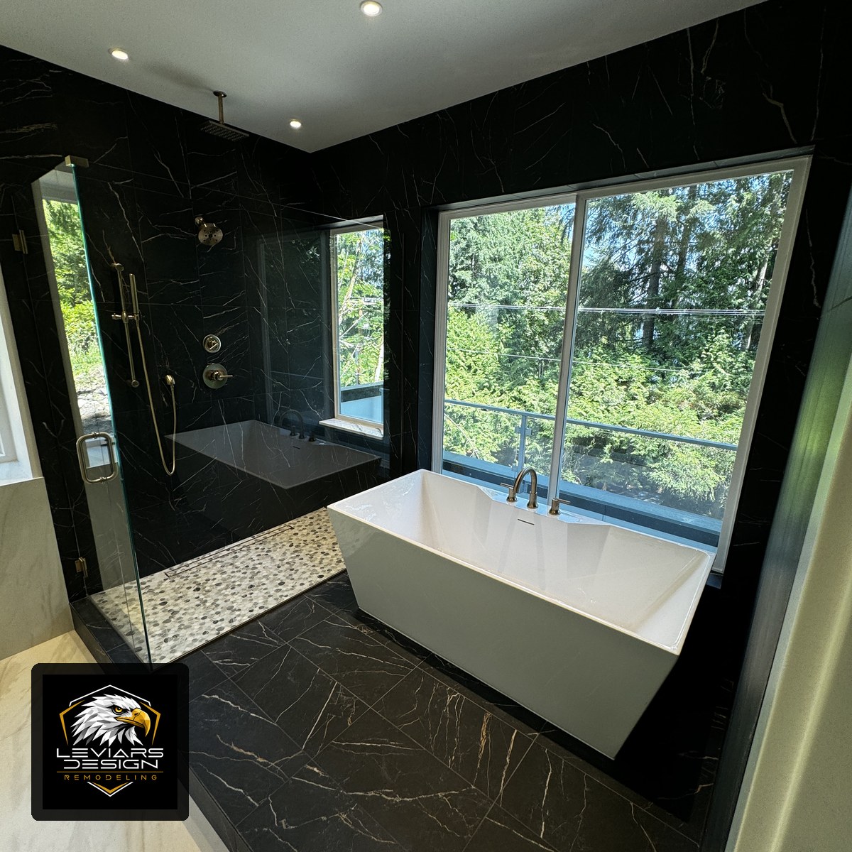Black stone-look walk-in shower and freestanding tub remodeled by LeviArs