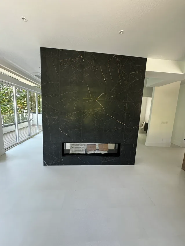 Floor-to-ceiling dark porcelain fireplace wall with a linear insert in Bellevue, Washington