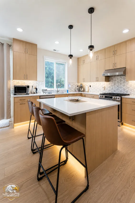 Kitchen island with seating and illuminated base cabinets in Edmonds, Washington