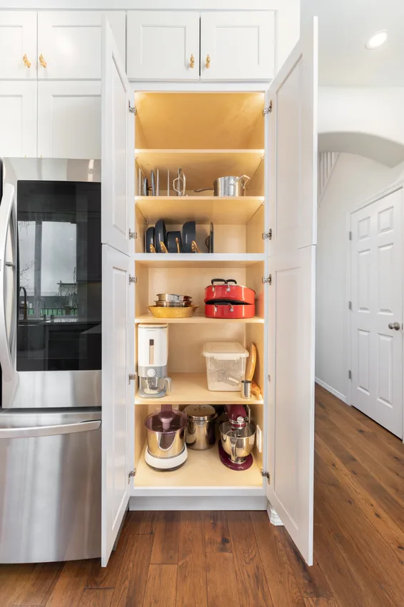 Open kitchen pantry with wood shelves and integrated lighting in Issaquah, Washington