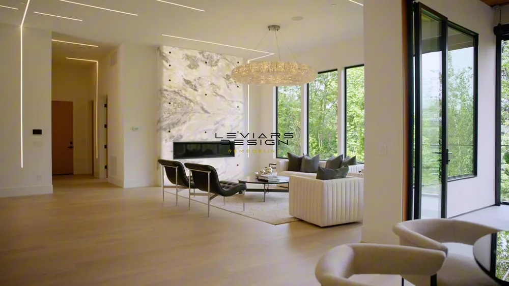 Video still of a living room with light wood flooring and a fireplace in Mercer Island, Washington
